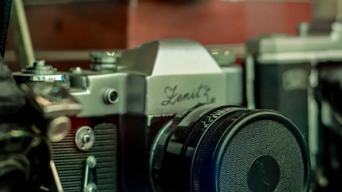 An old film camera resting among vintage equipment