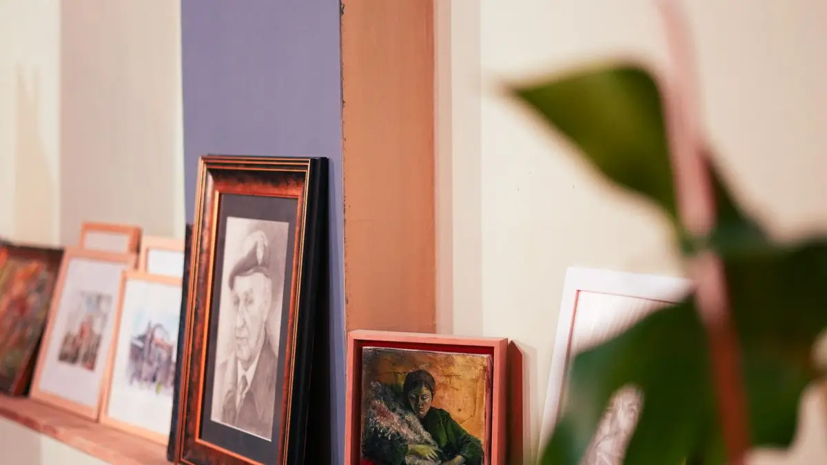 Framed family photographs standing on a shelf