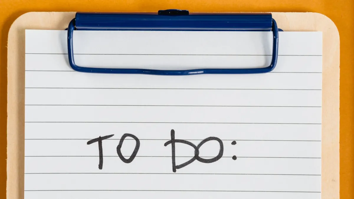 A clipboard holding lined paper headed To do