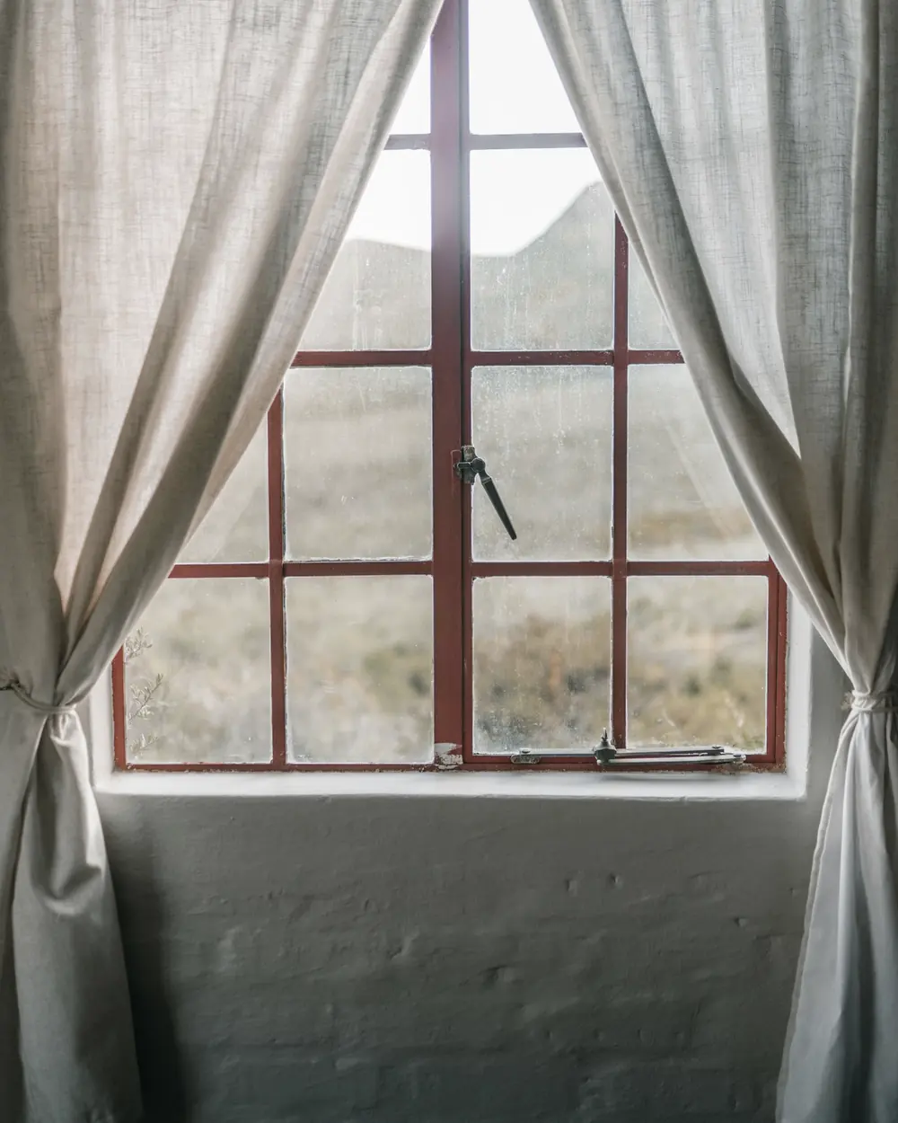 Soft daylight through a curtained window in a quiet home